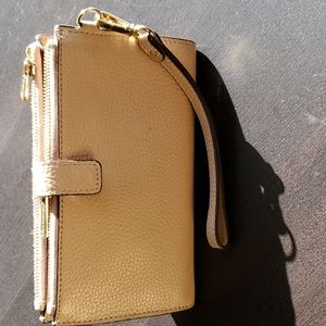 Michael Kors  tan, leather wallet.  detachable wrist strap.       7 1/4 X 4 1/2.
